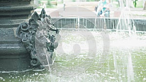 Close up of Fountain with tiles in background. Water dripping down the of fountain