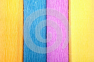 Close-up of four colored crepe paper rolls, texture for backdrop