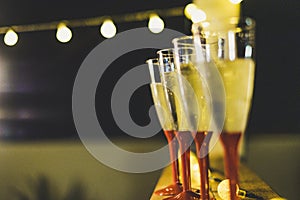 Close up of four glasses with champagne or wine the night of the new year ready to celebrate it - night and dark background