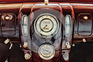 American classic car with speedometer and clock