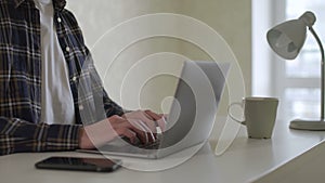 Close up of freelancer businessman hands typing on computer keyboard.