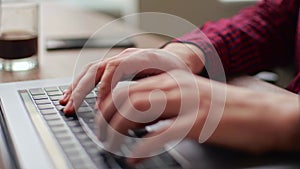 Close up of freelancer's developer hands typing program code on laptop keyboard in coworking. Businessman at work in