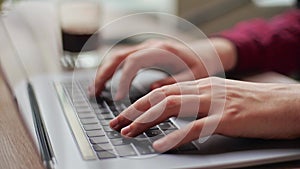 Close up of freelancer's developer hands typing program code on laptop keyboard in coworking. Businessman at work in