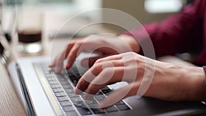 Close up of freelancer's developer hands typing program code on laptop keyboard in coworking. Businessman at work in