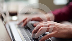 Close up of freelancer's developer hands typing program code on laptop keyboard in coworking. Businessman at work in