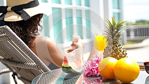 Close up frees fruits. Summer time and Vacations. Women lifestyle relaxing and drinking juice orange