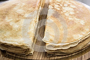 Close up of french crepes, thin pancakes on a wooden board