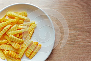 Close up with french fries or fried potato on a white plate. Flat lay, top view