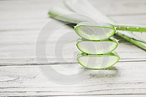 Close-up Fresh Aloe vera sliced with water drops on white wood background