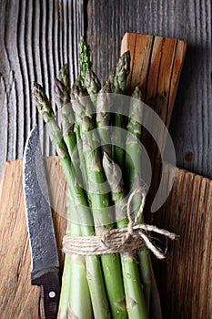 Close up of fresh asparagus sprouts on wooden board