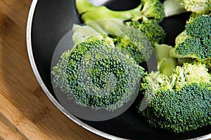 Close up on Fresh broccoli solated in pan on wooden background