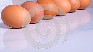 Close-up of fresh brown eggs ,in one line,side view,copy space,background