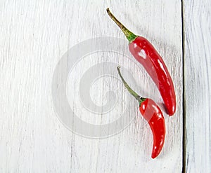 Close up fresh chili peppers on wooden background