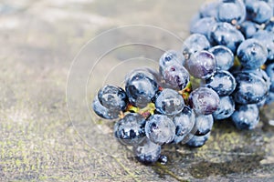 Close up Fresh grapes are placed on a wooden table in the background.