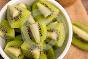 Close-up fresh green kiwis slice in the white bowl