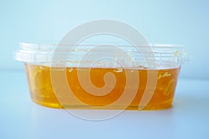 close up of fresh honey with comp in a jar