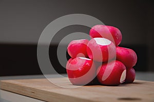 close-up, fresh juicy radish lies in a slide on a wooden board. advertising banner