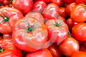 Close up of fresh, juicy, ripe tomatoes pile. lycopene and antioxidant in fruit nutrition good for health and skin. flat lay. photo