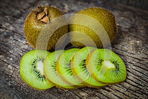 Close up fresh kiwi fruit on old wood background.