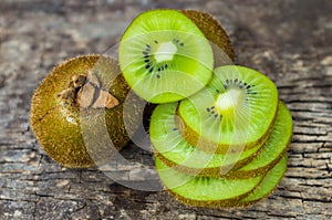 Close up fresh kiwi fruit on old wood background.