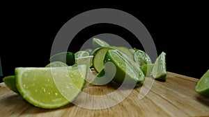 Close-up of fresh lime rests upon a rustic wooden cutting board. Comestible.