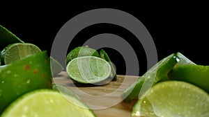 Close-up of fresh lime rests upon a rustic wooden cutting board. Comestible.