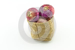 Close up fresh onion in sacks sisal  isolated on white background on top view