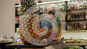 Close-up of a fresh pineapple on a shelf in a store.