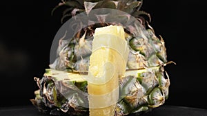 Close up of fresh pineapple with slice of peel pineapple insert. Comestible.