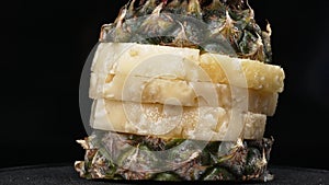 Close up of fresh pineapple with slice of peel pineapple insert. Comestible. photo