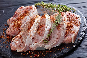 Close up of fresh pork chops with spices and thyme