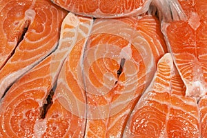 Close-up fresh raw salmon steaks background. Fish fillet at market counter. Healthy food