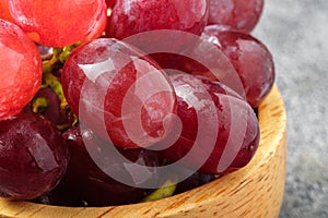 Close up Fresh red grapes on a wooden cup