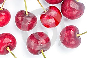 Close up fresh and refrigerated cherries and water drops on whit