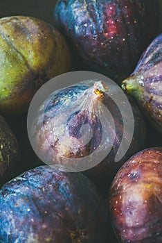 Close-up of fresh ripe seasonal purple figs, vertical composition