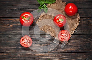 Close-up of fresh, ripe tomatoes on wood background