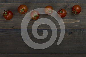 Close-up of fresh, ripe tomatoes on wood table