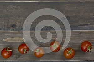 Close-up of fresh, ripe tomatoes on wood table