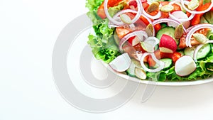 Close-up of a fresh salad of cucumbers, tomatoes, radishes, onions and other vegetables