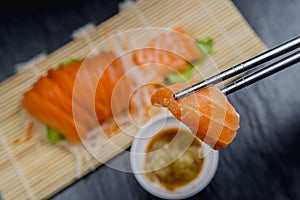 Close up fresh salmon sashimi set salad on bamboo plate, Japanese food