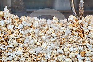 Close up with a fresh salty popcorn. Machine popcorn maker texture background