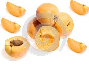 A close-up of fresh and sliced apricots.