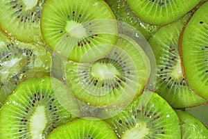 Close-up fresh slices of kiwi fruit on white background. Slices of kiwi fruit in sparkling water on white background