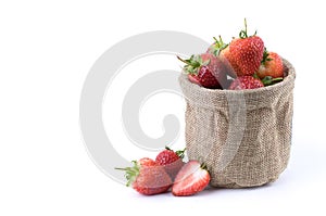 Close up fresh strawberries fruits with sliced half in burlap sack isolated on white background. Fruit and healthy concept