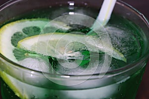 Close up of a fresh summer drink, mint with soda, ice cubes and