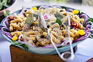 Close up of fresh and tasty italian pasta meal food - concept of restaurant and catering service for event or party celebration -
