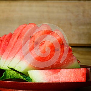 Close-up of fresh watermelon slices over wooden background. Selective focus