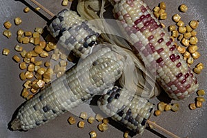 Close-up of Fresh waxy corn or Sweet glutinous corn and Corn kernels on Round ceramic tray