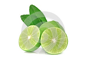 Close-up of Fresh whole limes with slices and leaves isolated on white background