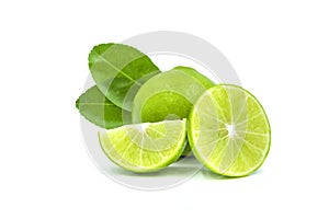 Close-up of Fresh whole limes with slices and leaves isolated on white background